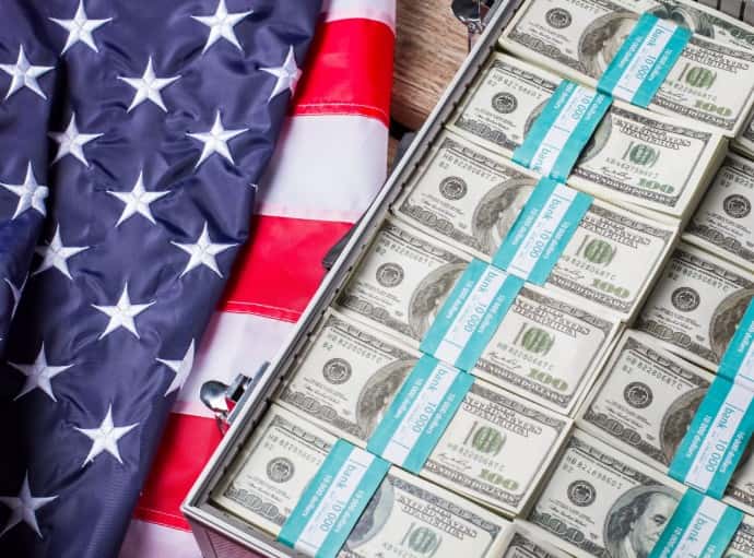 Old USA flag and dollars. Cash laying beside aged flag. Your questions about the stimulus bill answered.