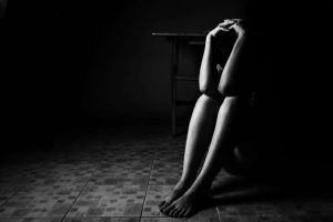 A woman alone with her head in her hands