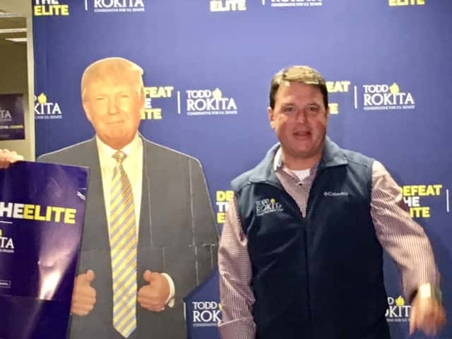Indiana Republican Todd Rokita Stands Next to a Cardboard Standup of President Donald Trump.