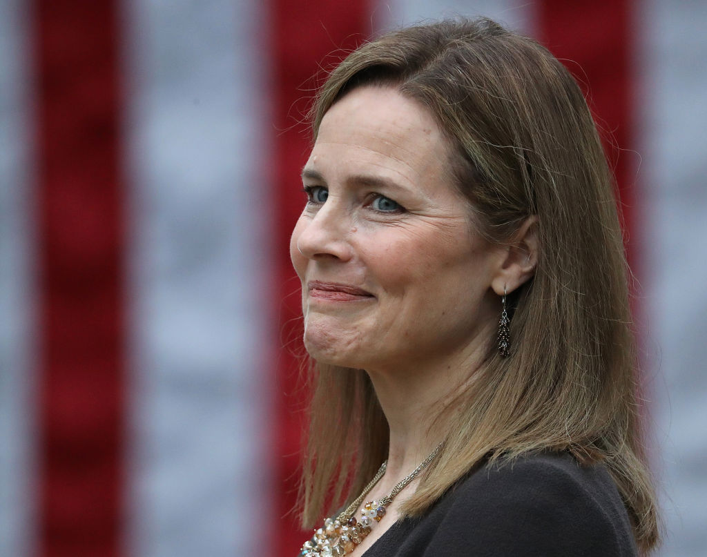 Seventh U.S. Circuit Court Judge Amy Coney Barrett looks on while being introduced by U.S. President Donald Trump as his nominee to the Supreme Court during an event in the Rose Garden at the White House September 26, 2020 in Washington, DC. With 38 days until the election, Trump tapped Barrett to be his third Supreme Court nominee in just four years and to replace the late Associate Justice Ruth Bader Ginsburg, who will be buried at Arlington National Cemetery on Tuesday. (Photo by Chip Somodevilla/Getty Images)