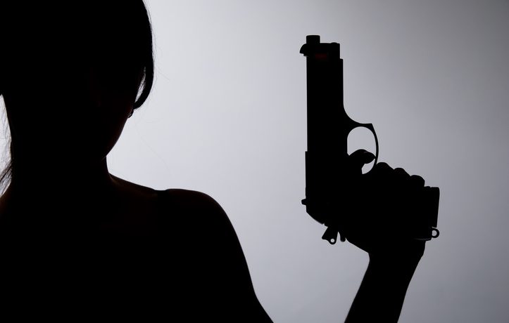 A photo of a person carrying a gun
