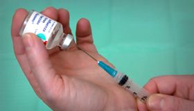 Filling a syringe with the Influenza Virus Vaccine Fluzone, close-up, 2003. Image courtesy Centers for Disease Control (CDC).