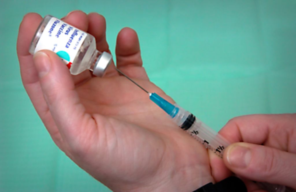 Filling a syringe with the Influenza Virus Vaccine Fluzone, close-up, 2003. Image courtesy Centers for Disease Control (CDC).