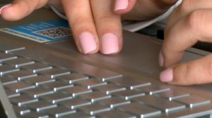 A parent working with their child on e-learning