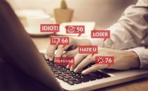 cyber bullying concept. people using notebook computer laptop for social media interactions with notification icons of hate speech and mean comment in social network