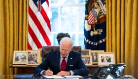 U.S. President Joe Biden signs executive actions in the Oval Office of the White House in Washington, D.C., U.S., on Thursday, Jan. 28, 2021. Biden will make it easier for Americans to buy health insurance during the pandemic, reopening the federal Obamacare marketplace with an order that's a step toward reinvigorating a program his predecessor tried to eliminate.