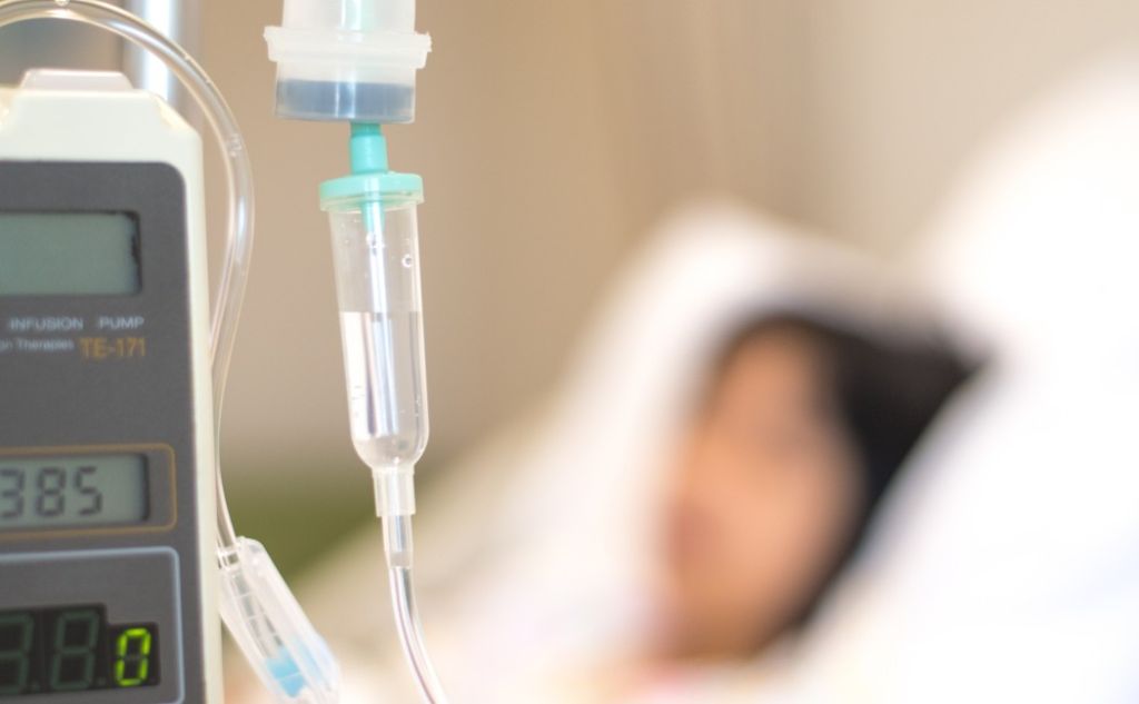Child patient with IV line in hand sleep on hospital bed. Medical palliation healthcare concept