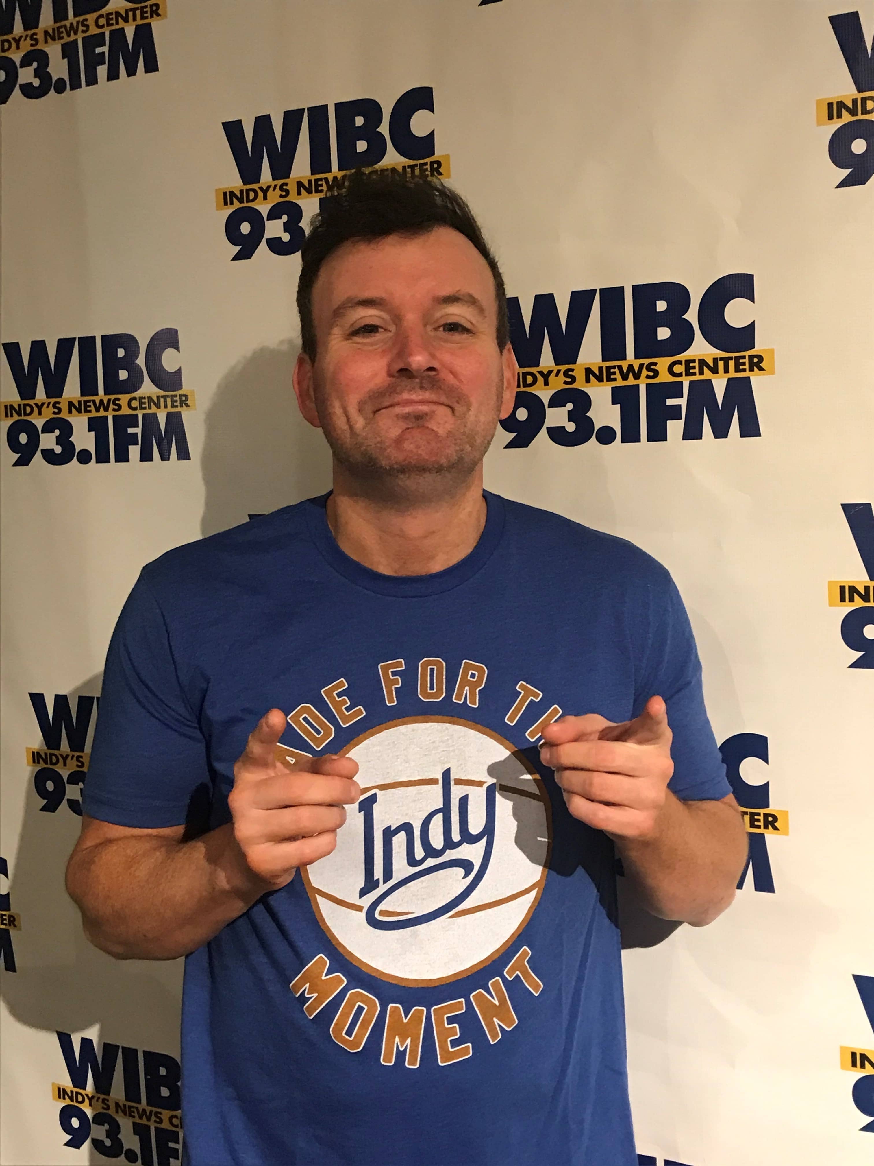 Matt Bair standing with a smirk on his face pointing both index fingers toward the camera