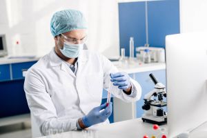Genetic consultant in white coat doing dna test in lab.
