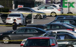 A crime lab technician (L) works in the parking lot of the site of a mass shooting at a FedEx facility in Indianapolis, Indiana on April 16, 2021. - A gunman has killed at least eight people at the facility before turning the gun on himself in the latest in a string of mass shootings in the country, authorities said. The incident came a week after President Joe Biden branded US gun violence an "epidemic" and an "international embarrassment" as he waded into the tense debate over gun control, a powerful political issue in the US. (Photo by Jeff Dean / AFP) (Photo by JEFF DEAN/AFP via Getty Images)
