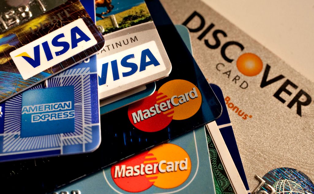 American Express, Discover, MasterCard and Visa credit cards are displayed for a photograph in New York, U.S., on Tuesday, May 18, 2010.
