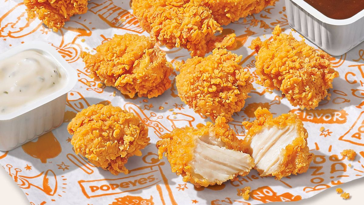 Popeye's chicken nuggets with two containers of dipping sauce.