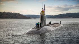 A US nuclear submarine hit an uncharted, underwater mountain, says the US Navy.
