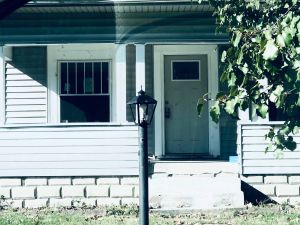 The home where three men were murdered on LaSalle St. It is white with a typical porch and yard.