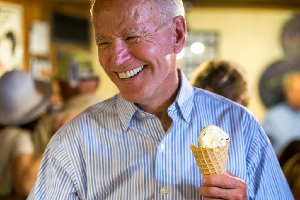U.S. presidential candidate and former Vice President Joe Biden laughs after getting served ice cream at Annabelle's Natural Ice Cream in Portsmouth, NH on July 12, 2019. (Photo by Nic Antaya for The Boston Globe via Getty Images)