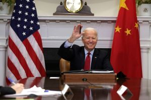 U.S. President Joe Biden waves as he participates in a virtual meeting with Chinese President Xi Jinping at the Roosevelt Room of the White House November 15, 2021 in Washington, DC. President Biden met with his Chinese counterpart to discuss bilateral issues. (Photo by Alex Wong/Getty Images)