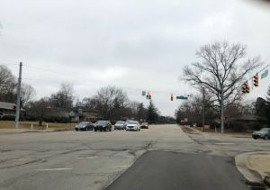Meridian St intersection with potholes and strip patches