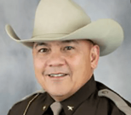 Sheriff Rich Kelly with a cowboy hat and brown uniform