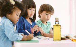 Group of kids drawing and painting with crayon together with fun in art class at the kindergarten. Preschool international, education concept.
