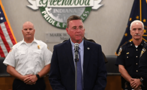 Greenwood Mayor Mark Myers talking into a mic at a press conference