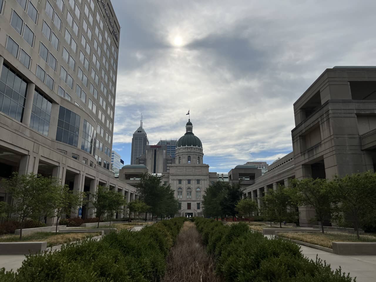 Landscape photo of Indiana's Statehouse, with each government center on opposing sides.