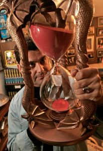 life31_047_mac.jpg Barry holds a replica of the famous hourglass used by the wicked witch in the film, "Wizard of Oz". Barry Barsamian, 47, who lives with his dad in the same house in Redwood Heights that he grew up in. It's a modest Oakland house - fr