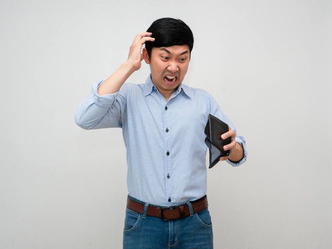 Asian man blue shirt feels shocked about no money in his wallet feels strain and headache isolated