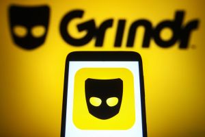In this photo illustration a Grindr logo is seen on a...