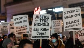 Protesters hold placards demanding justice following the...