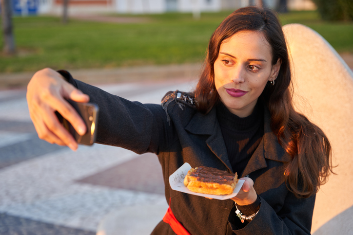 Girl taking a selfie with a chocolate waffle