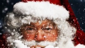 Father Christmas blowing snow, portrait, close-up