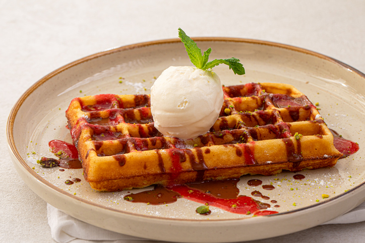 Portion of sweet belgian waffles with ice cream