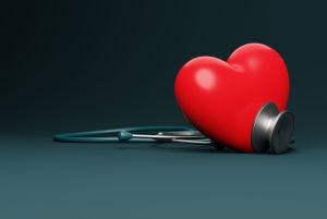 Heart and stethoscope on a dark background.