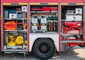 The side view of equipment packed neatly inside a fire truck