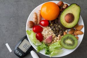 Healthy food on plate lowering blood sugar and glucometer, diabetes diet concept