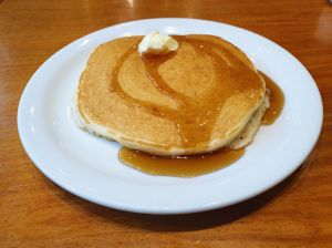 Delicious pancake with butter and syrup