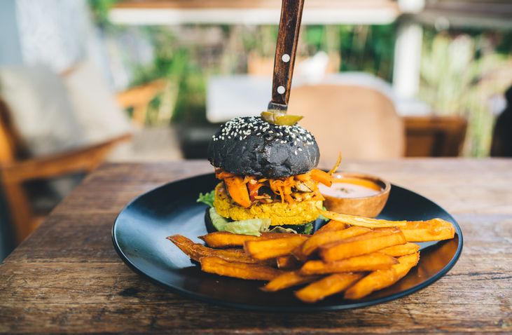Delicious black burger in cafe in daytime