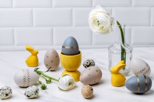 Easter eggs and Easter home decor yellow bunnies on a light background