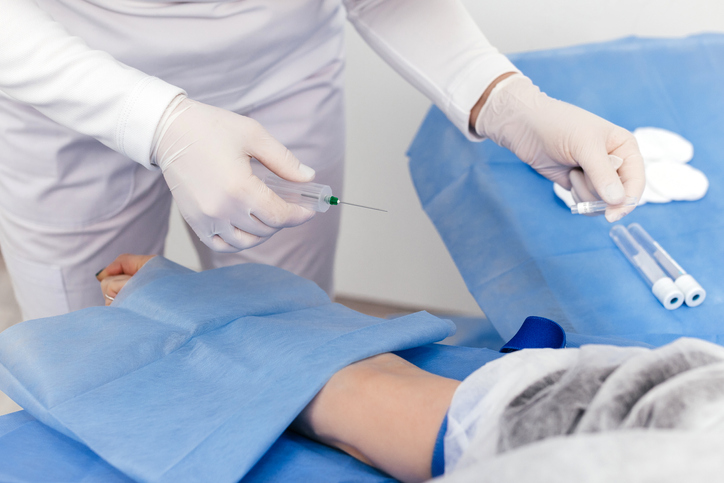 Laboratory worker doctor takes a blood sample for analysis, hand closeup. Blood sampling in the laboratory. Taking a blood in cosmetology clinic before PRP therapy procedure