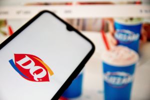In this photo illustration a Dairy Queen (DQ) logo seen...