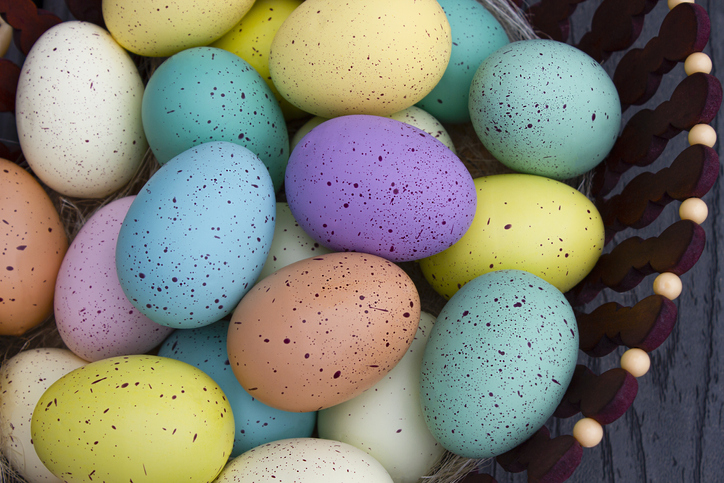Background of colorful Easter eggs in the wooden basket