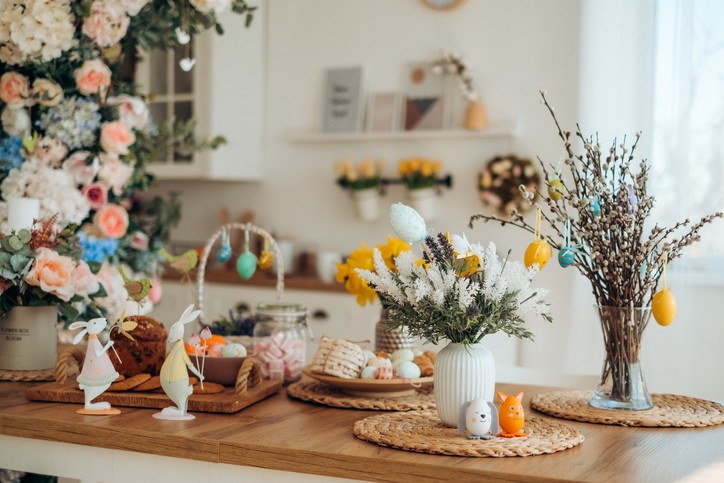 Easter decor on a wooden table and Easter bunny cake, Easter cake on a wooden tray, spring flowers, sweet table for the holiday, Easter holiday