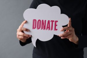 Woman showing Donate on speech bubble