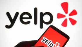 In this photo illustration a Yelp logo is seen on a...