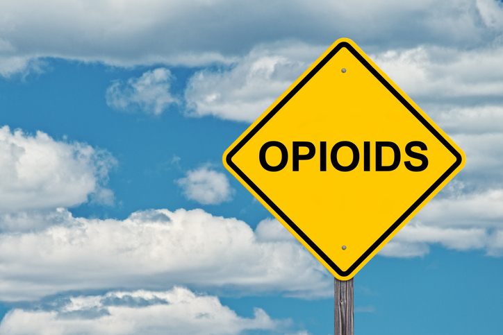 Opioids Ahead Caution Sign - Blue Sky Background