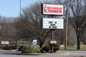 A sign with the Dunkin' Donuts logo is seen at its...