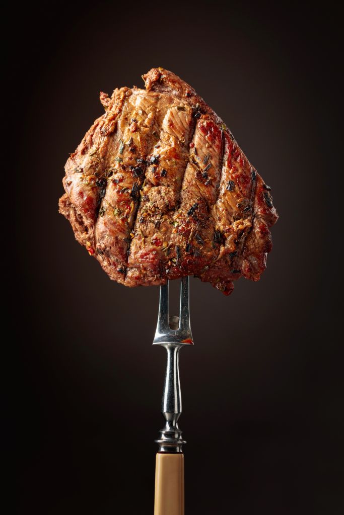 Beef steak on a fork.