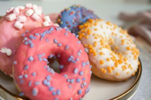 Top view of assorted glazed donuts. Various colorful glazed doughnuts with sprinkles.