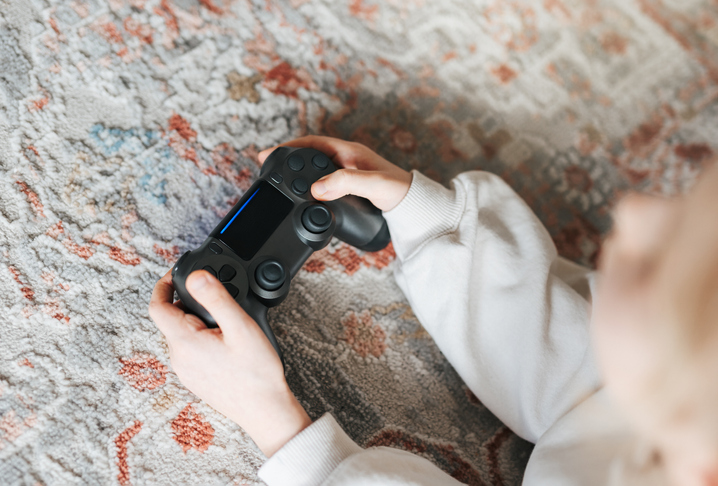 Girl playing video game at home