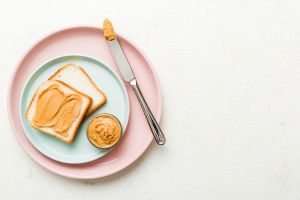 Peanut butter sandwiches or toasts on light table background.Breakfast. Vegetarian food. American cuisine top view vith copy space